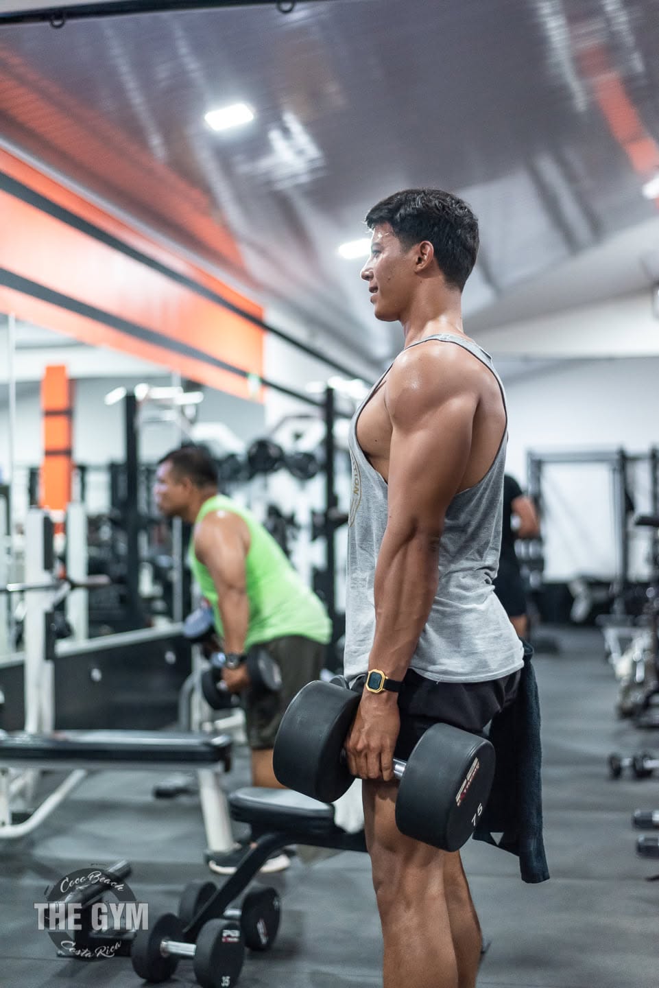 Member training with dumbbells at The Gym Coco Beach