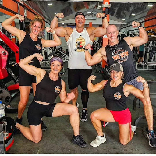 Members of The Gym Coco Beach flexing together after a workout