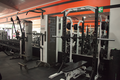 Bench press and weight rack at The Gym Coco Beach